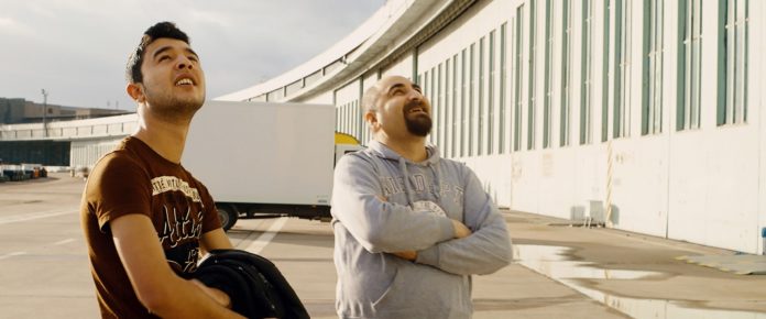 Dos nazistas aos refugiados no documentário de Karim Aïnouz Ibrahim e Qutaiba observam sua "casa" em Aeroporto Central, de Karim Aïnouz.